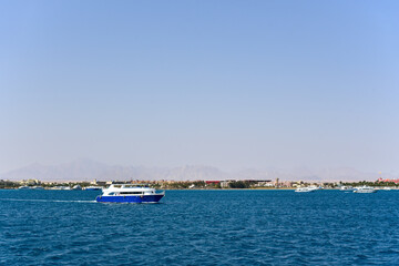 The yacht sails on the sea along the coast in Africa