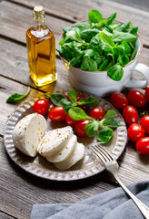  Mozzarella cheese ball with salad corn, cherry tomatoes and olive oil.