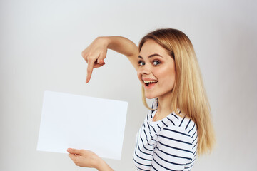 woman holding a sheet of paper in her hands lifestyle striped t-shirt cropped view Copy Space  