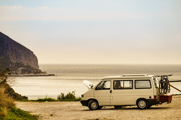 Broken camper van on seaside cliff, Spain