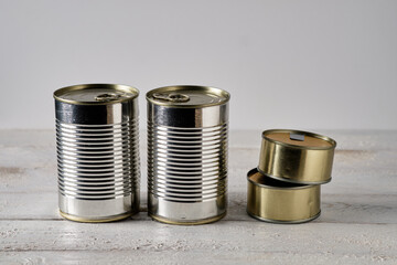 Tin cans on white wooden table