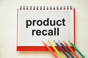 text product recall written on a white notebook with pencils