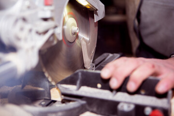 worker processes a wooden Board on a circular machine