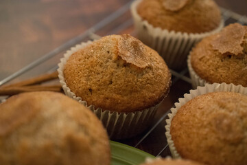 Freshly baked delicious homemade cinnamon muffins on wire rack. 