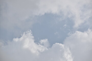 Blue sky with puffy white clouds.