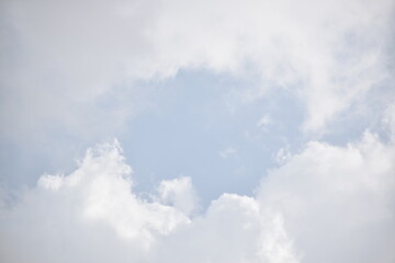 Blue sky with puffy white clouds.