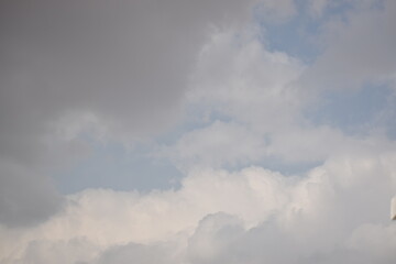 Fototapeta na wymiar Blue sky with puffy white clouds.