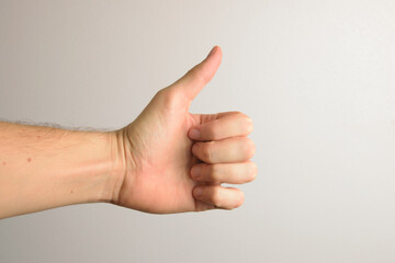 hand with thumb up on white background. Concept of positivity and good