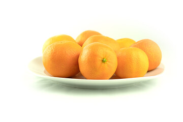 Fresh tangerines in a plate on a white background