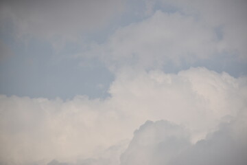 Blue sky with puffy white clouds.