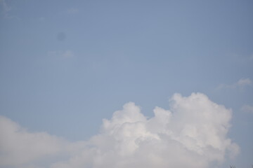 Blue sky with puffy white clouds.