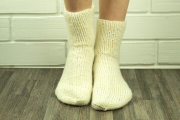 Handmade socks from white threads, crocheted socks close-up