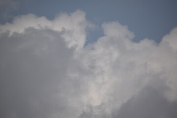 Blue sky with puffy white clouds.