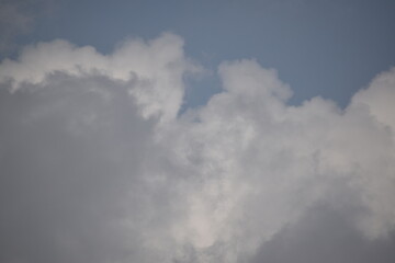 Blue sky with puffy white clouds.
