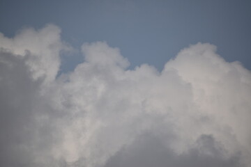 Blue sky with puffy white clouds.