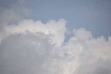 Blue sky with puffy white clouds.