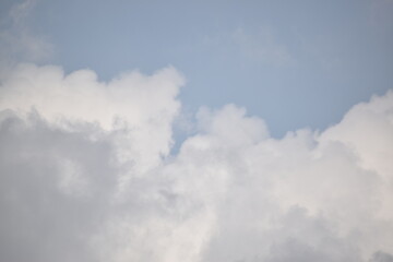 Blue sky with puffy white clouds.