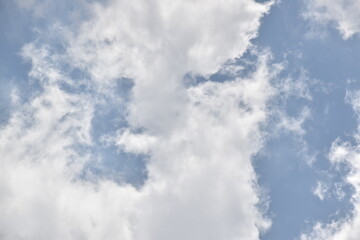 Blue sky with puffy white clouds.