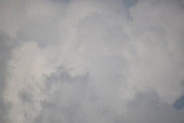 Blue sky with puffy white clouds.