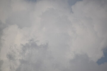 Blue sky with puffy white clouds.
