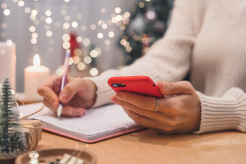 Goals plans make to do and wish list for new year christmas concept writing in notebook. Woman hand...