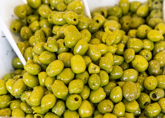 Green salted olives on the market (Selective focus)