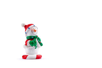ceramic figure of a snowman in a red hat, isolate on a white background