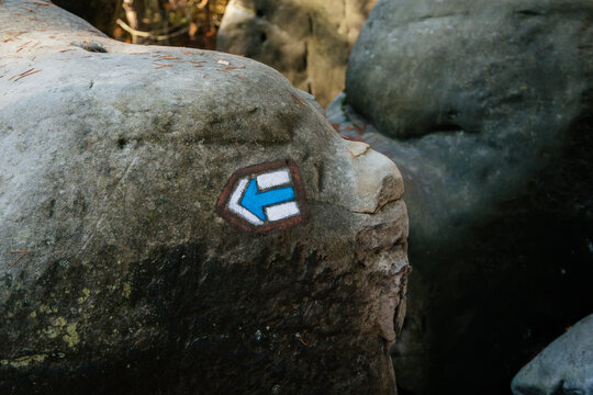 Blue tourist route hiking sign, the detail of traditional colorful Czech tourist marking on hiking trails, Bohemian Paradise, Besednicke skaly above Mala Skala, Czech Republic