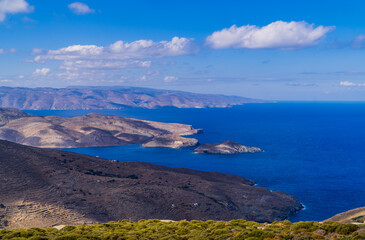 Coastal landscapes on the island of Tinos, Cyclades, Greece with the island of Andros in the background