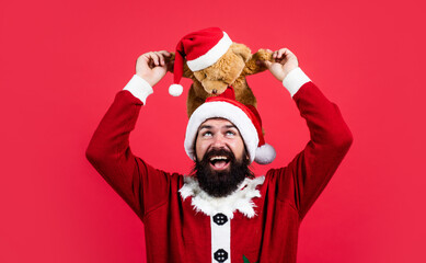 bearded santa man hold toy in hat smiling while prepare for celebrating happy new year party and...