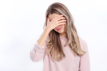 Woman closes her eyes with her hand