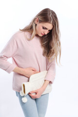Woman with hot bottle on her belly isolated