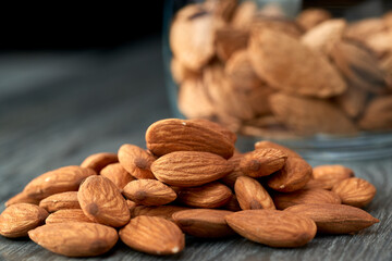 Almond kernels lie on a dark background.Selective focus.Salted almonds.