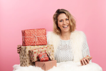 Attractive middle age woman with christmas gifts