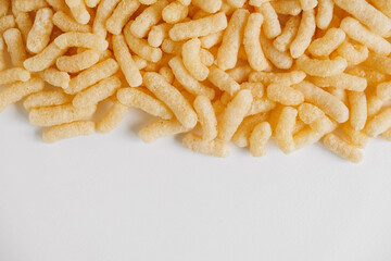 Corn sticks scattered on a white background. Top view. Place for your text