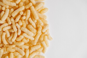 Corn sticks scattered on a white background. Top view. Place for your text