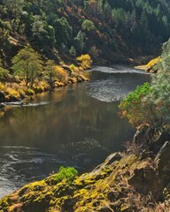 The Trinity river flows through an autumn mountain pass.