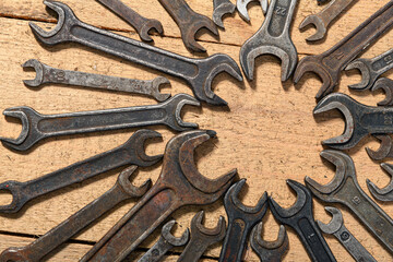 old vintage hand tools - set of wrenches on a wooden background with blank space for text