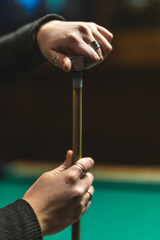 chalking up a pool cue