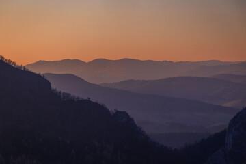 Mountains colored at sunset in autumn..The ridges of the mountains are condensed from the perspective of a telephoto lens.