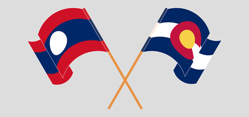 Crossed and waving flags of Laos and The State of Colorado