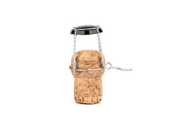 Champagne cork with muzlet upright on a white background.