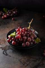 Red grapes on the black table