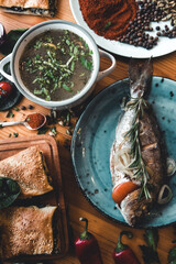 Fresh fish dorado. Dorado and ingredients for cooking on a table.