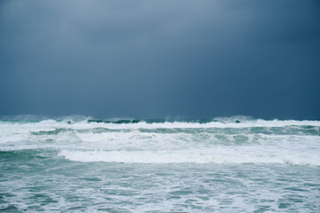 Naklejka na ściany i meble Waves on the ocean during a rainy and windy storm