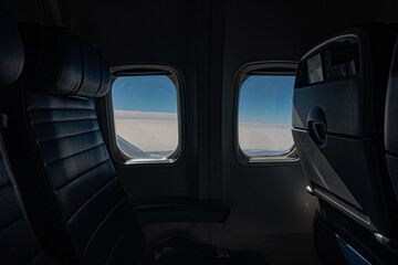 Blue Sky and clouds through two airplane windows.