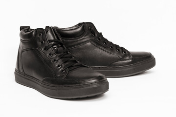 Shoes, warm low boots for the cold season for boys and men on a light background. These boots are not afraid of moisture and frost