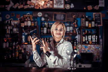 Girl bartender makes a cocktail on the porterhouse