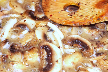 Macro of a pan of mushroom cream sauce cooking