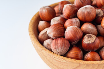 fresh natural hazelnuts on a white acrylic background